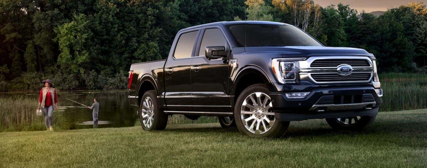A blue 2021 Ford F-150 for sale is shown from the front at an angle.