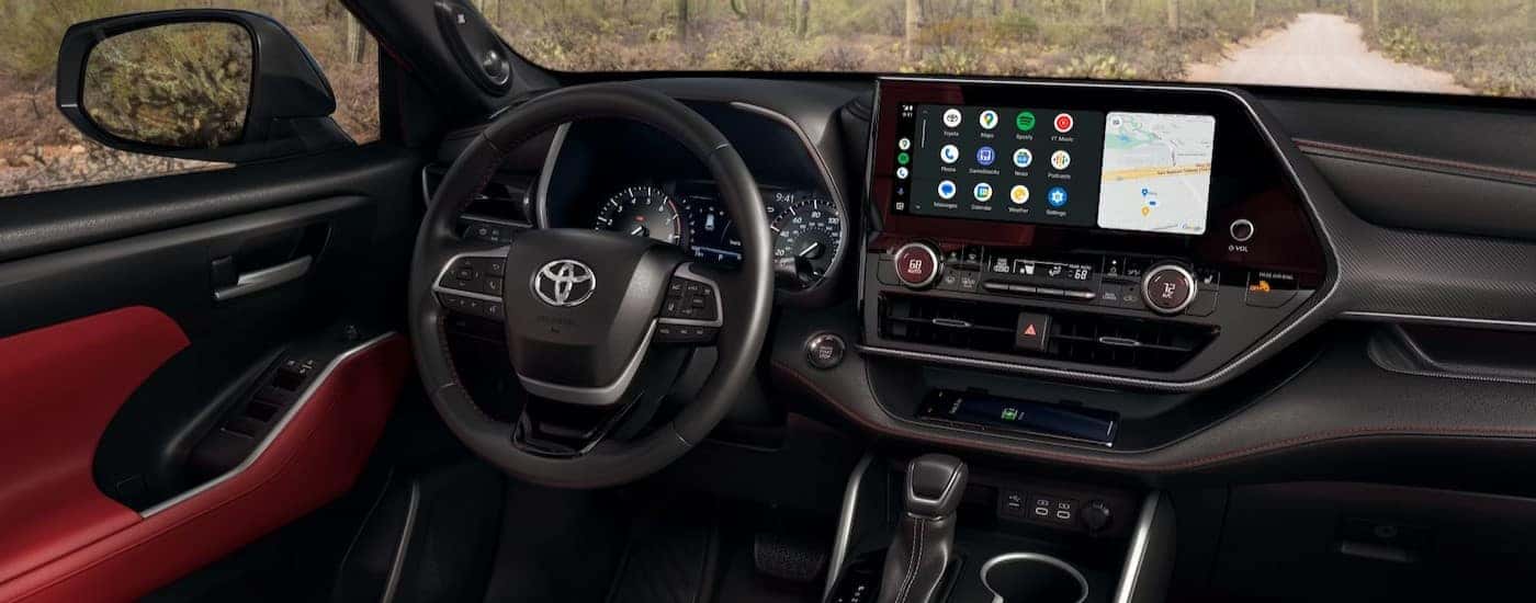The black and red interior and dash in a 2024 Toyota Highlander.