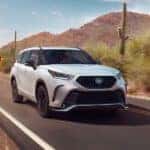 A white 2023 Toyota Highlander XSE for sale in Columbus driving on an open road.