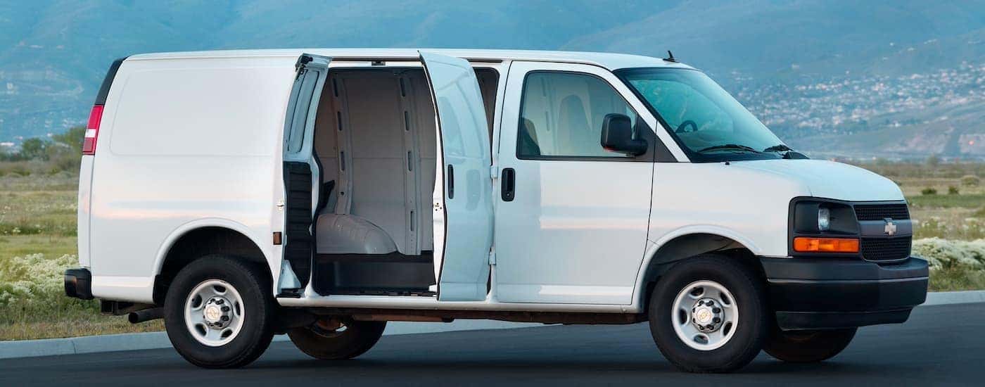 A white 2015 Chevy Express 2500 parked with an open side door.