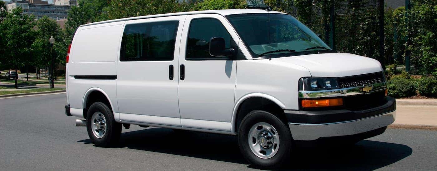 A white 2016 Chevy Express 2500 parked by a curb.
