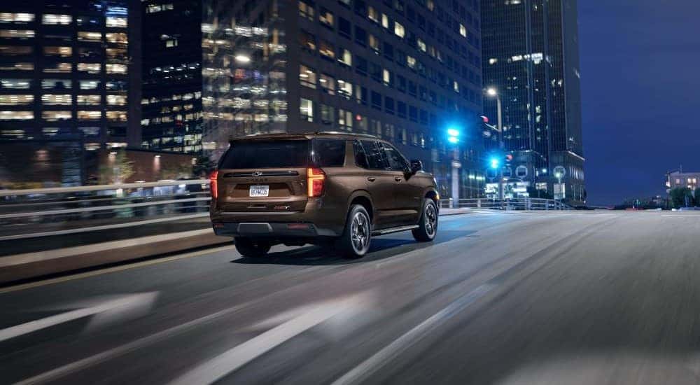A brown 2021 Chevy Tahoe driving in a city