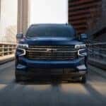 A dark blue 2021 Chevy Tahoe for sale driving down the street