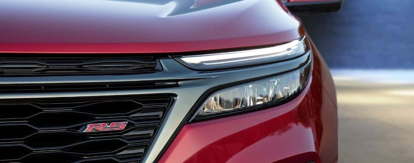 Headlight and grille on a red 2024 Chevy Equinox RS.