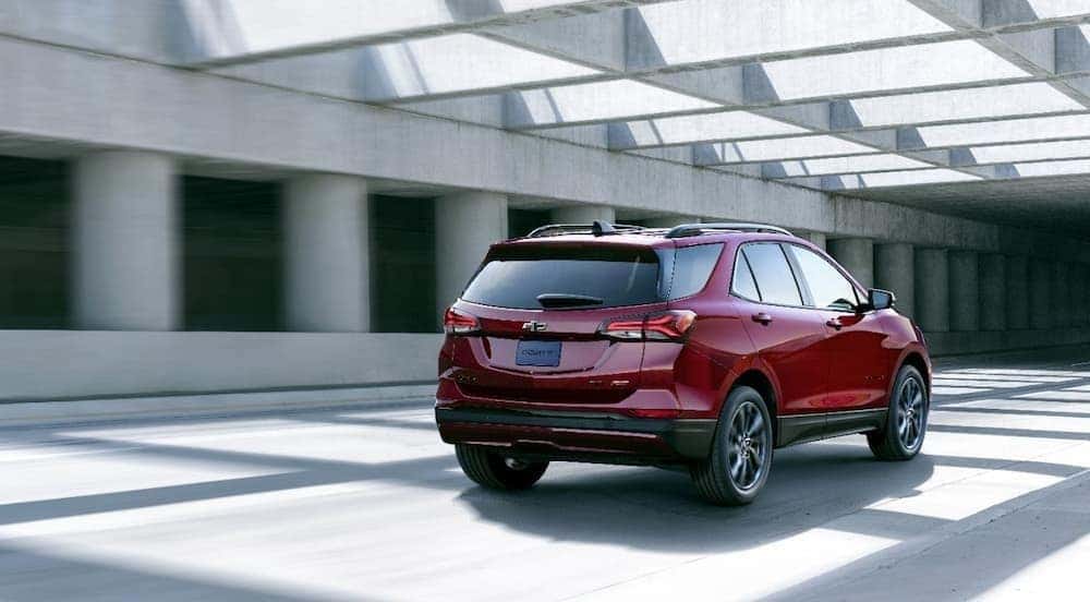 A red 2024 Chevy Equinox RS driving in a tunnel.