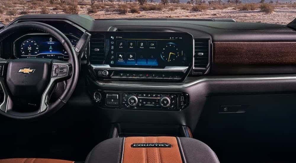 The black and brown interior and dash in a 2024 Chevy Silverado 2500 High Country.