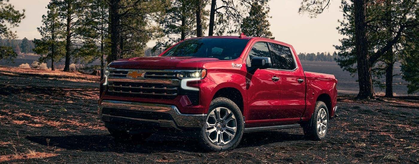 Red 2023 Chevy Silverado 1500 Z71 off-roading on dirt.
