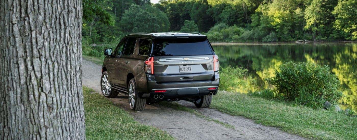 A 2021 Chevy Tahoe High Country on a dirt road near a lake