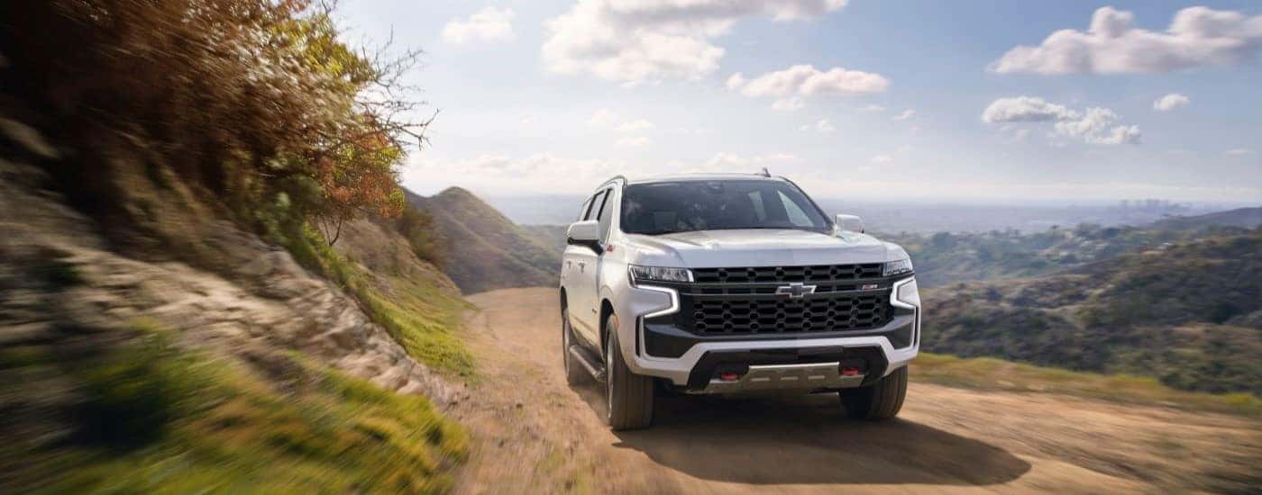 A white 2021 Chevy Tahoe driving off-road