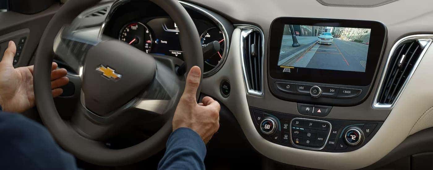 Close-up of steering wheel and dash in a 2024 Chevy Malibu for sale.