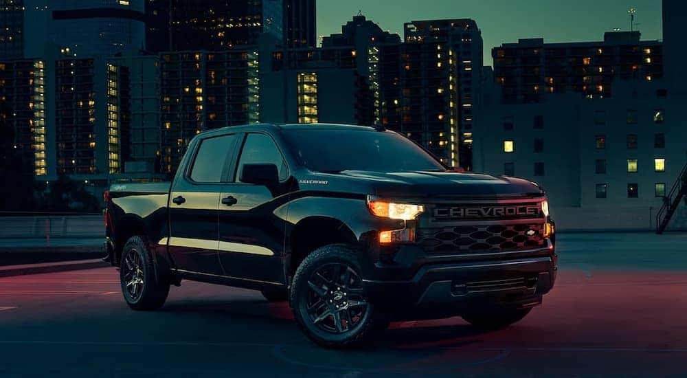 A black 2024 Chevy Silverado 1500 from the front at an angle.