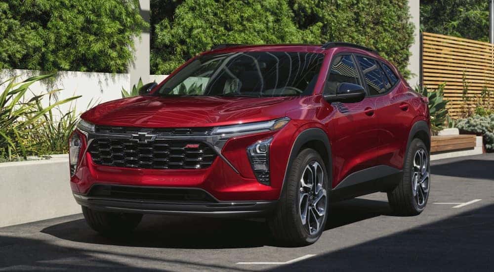 A red 2024 Chevy Trax parked in a city.
