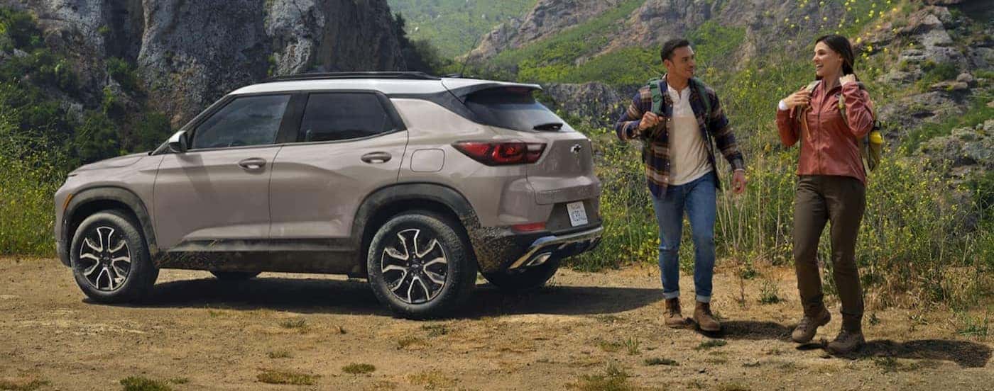 A brown 2026 Chevy Trailblazer parked near two hikers.
