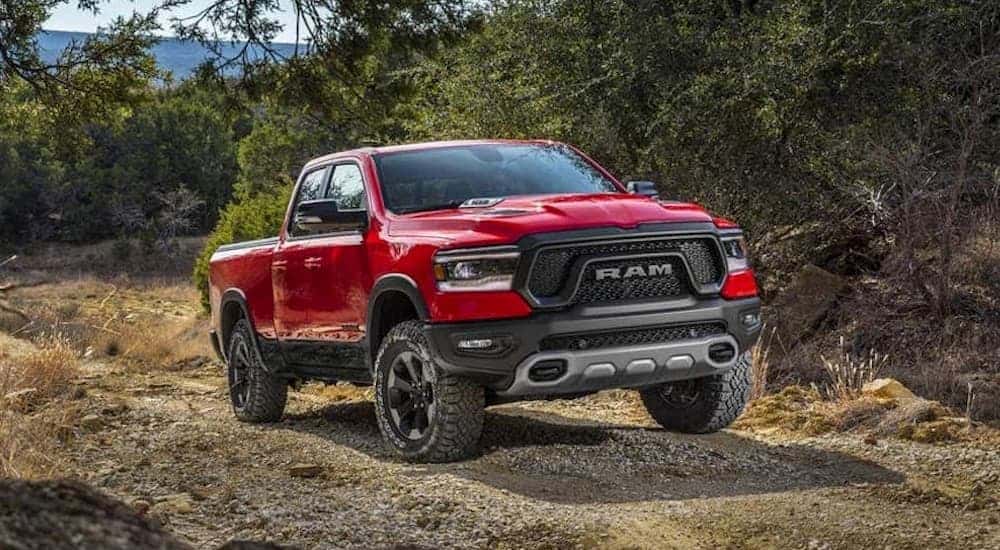 A red 2019 Ram 1500 parked off-road in sand