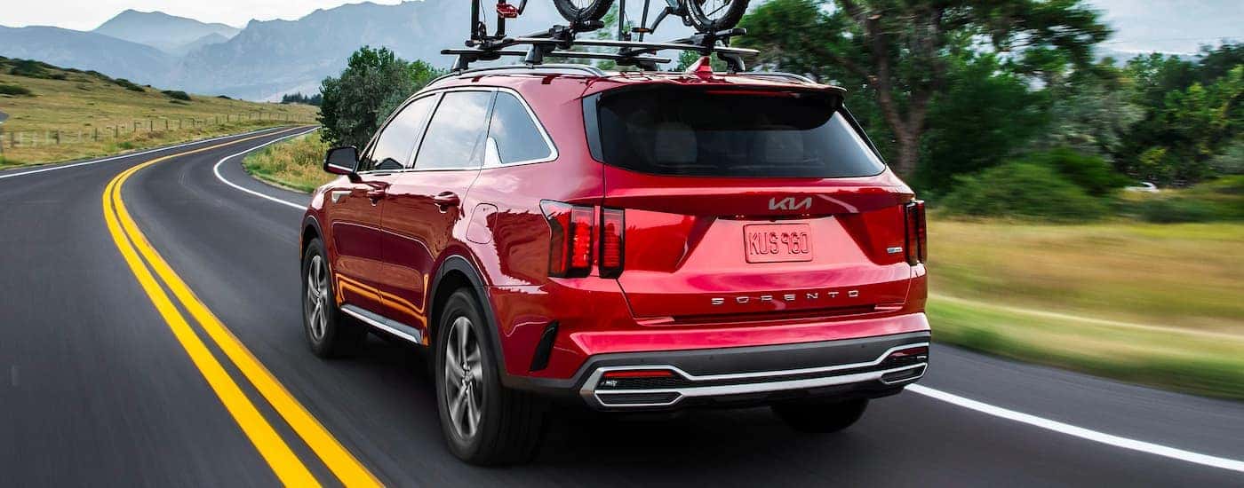 A red 2022 Kia Sorento driving on a highway.