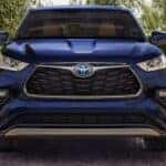 A blue 2022 Toyota Highlander Hybrid Platinum parked in a driveway