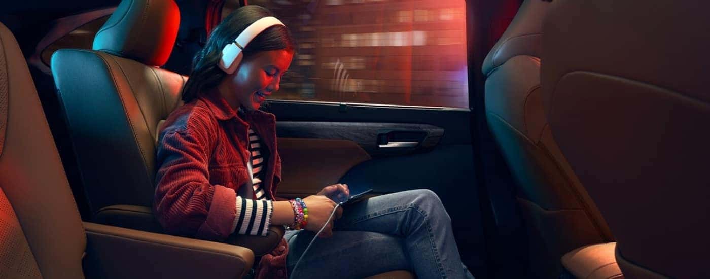 A child using a tablet in a 2022 Toyota Highlander.