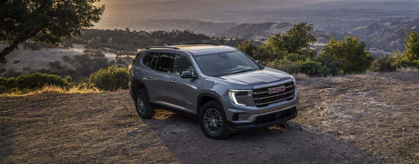 A grey 2025 GMC Acadia Elevation parked off-road