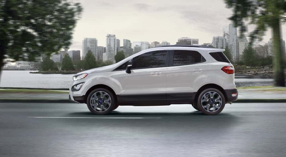 A white 2022 Chevy Trax driving down a city street