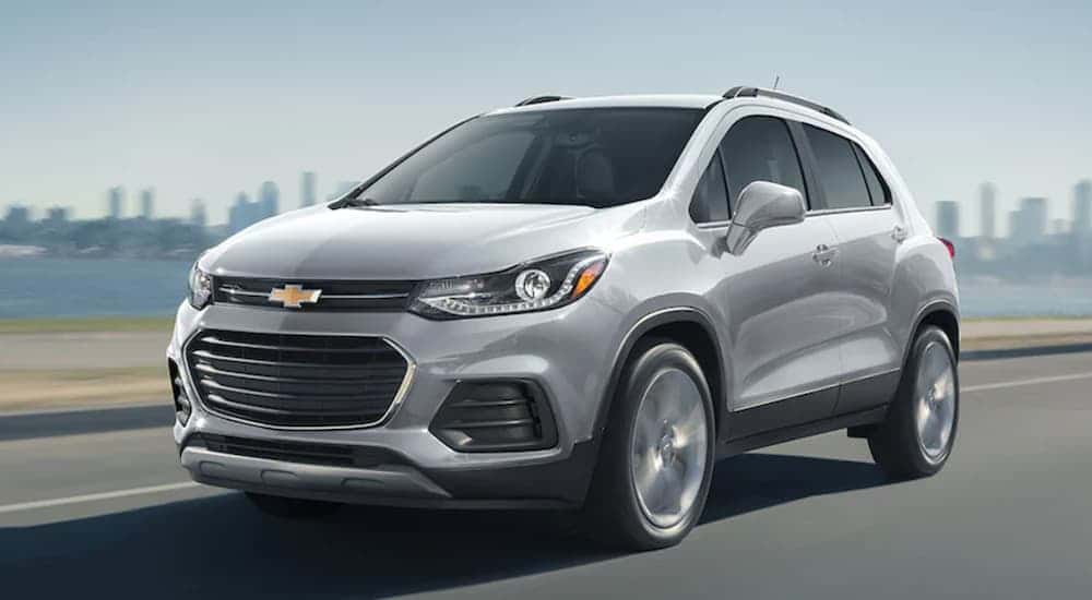 A silver 2022 Chevy Trax driving in a city