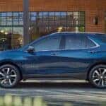 A blue 2023 Chevy Equinox parked outside a cafe