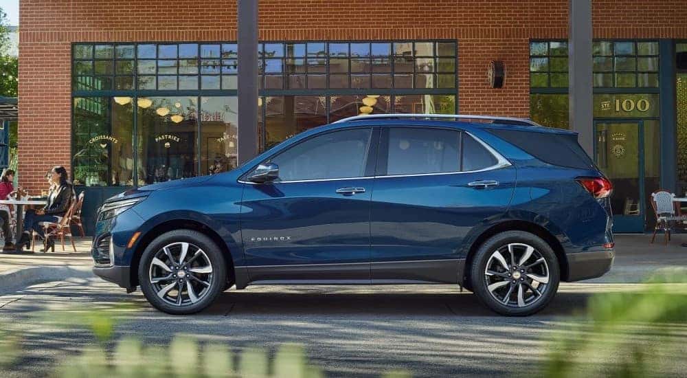 A blue 2023 Chevy Equinox parked outside a cafe