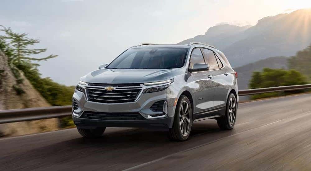 A silver 2023 Chevy Equinox driving down a highway