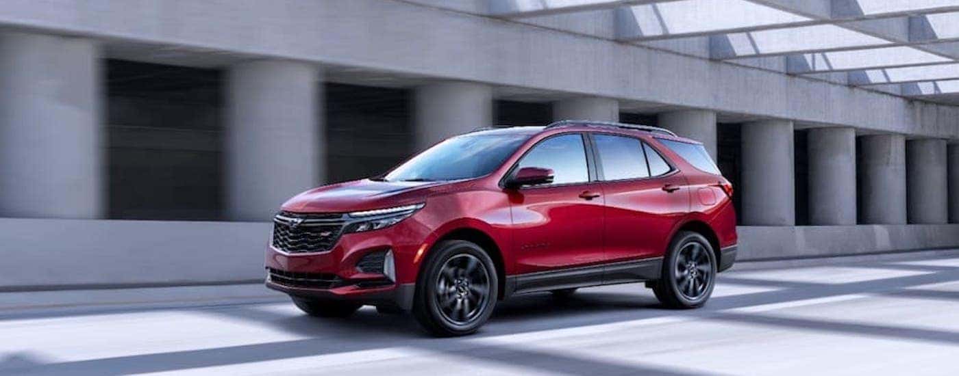 A red 2023 Chevy Equinox from the side.