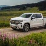 White 2019 Chevy Silverado 1500 High Country for sale in Columbus driving off-road.