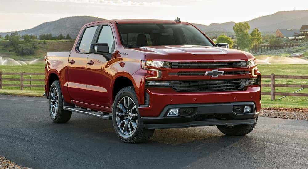 Red 2021 Chevy Silverado 1500 for sale in Indianapolis driving down a road.