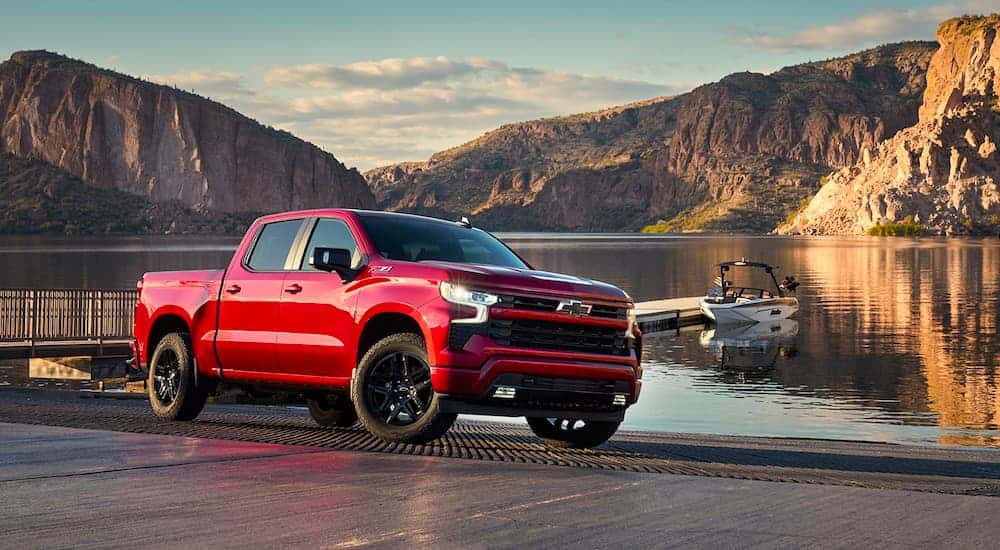 Red 2022 Chevy Silverado 1500 Z71 parked near a lake.