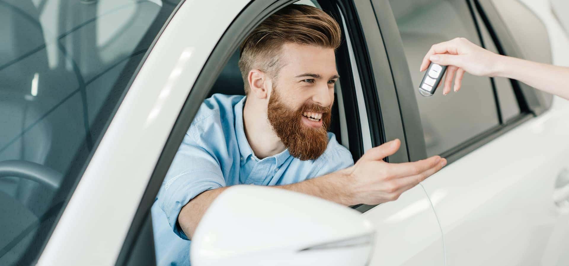 man receiving keys at dealership
