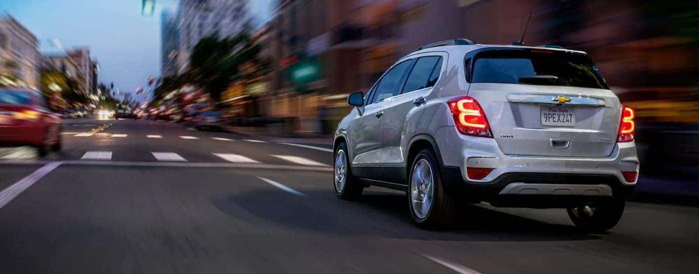 A silver 2022 Chevy Trax driving in a city