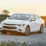 White 2018 Chevy Malibu from the front at an angle.