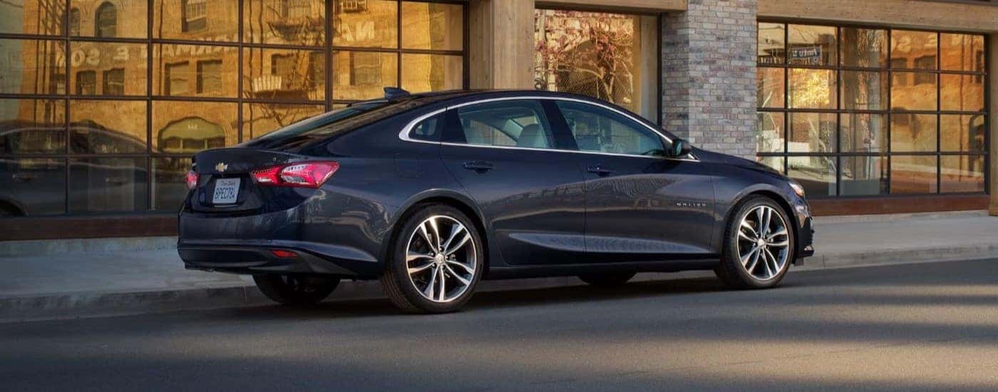 A black 2023 Chevy Malibu parked on a city street