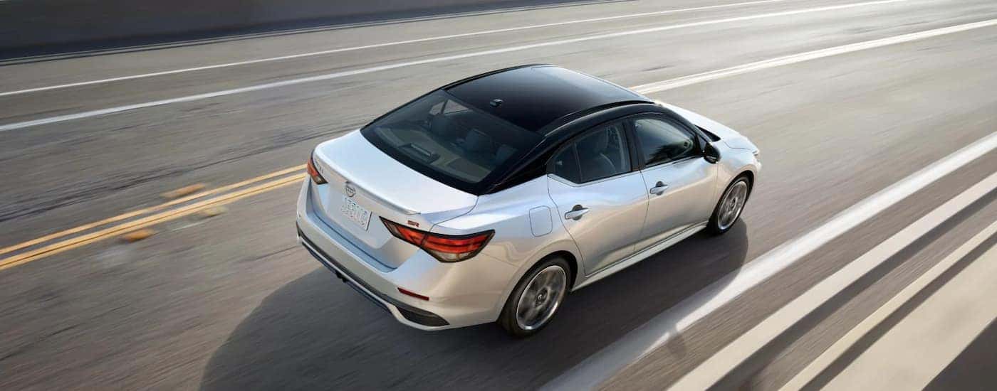 A white 2025 Nissan Sentra driving down a road