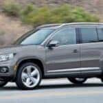 A gray 2017 Volkswagen Tiguan for sale driving on a highway.