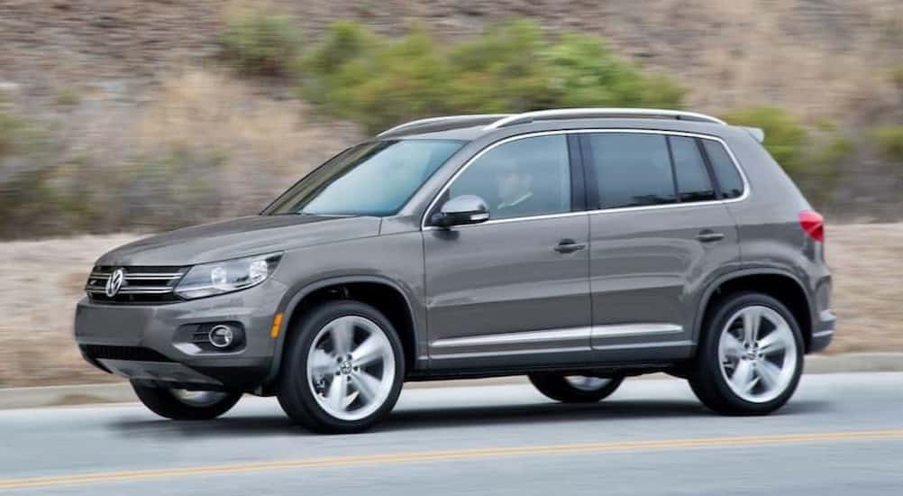 A gray 2017 Volkswagen Tiguan for sale driving on a highway.