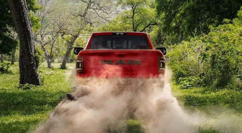Red 2023 Ram 2500 driving down a trail