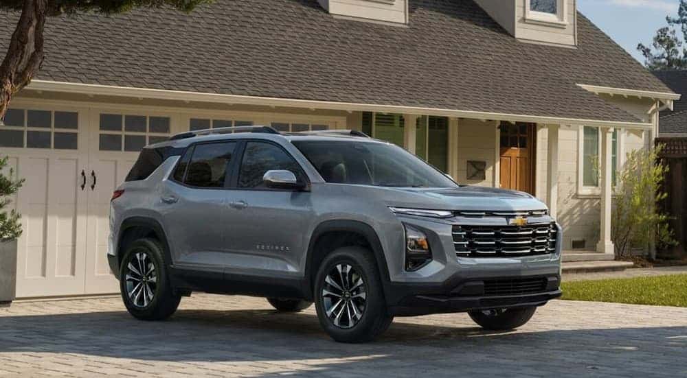 A silver 2025 Chevy Equinox for sale parked on a driveway.