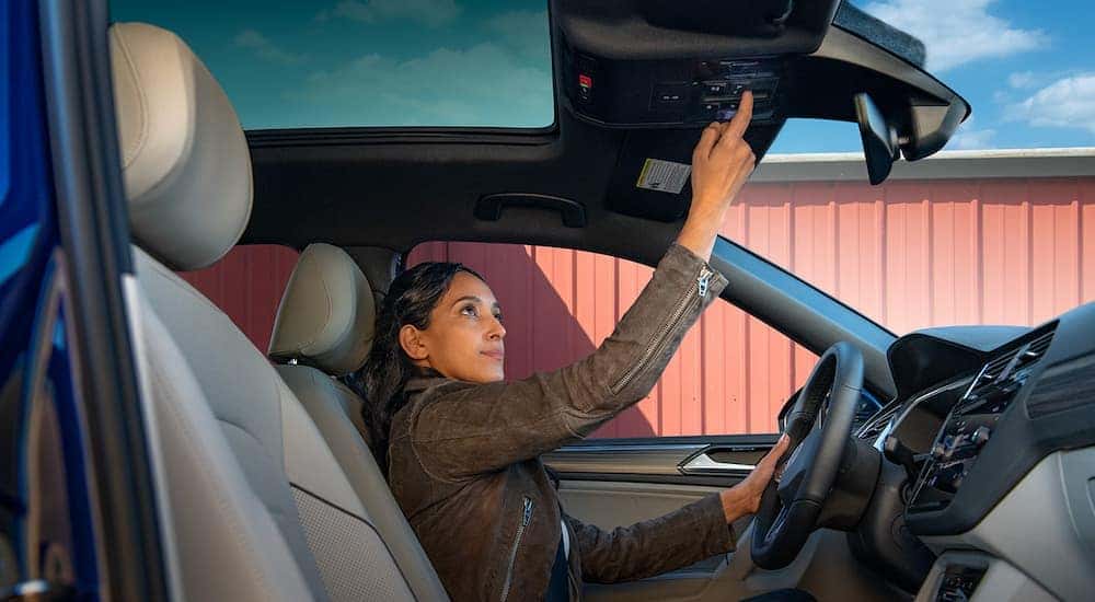 A person driving in a 2021 Volkswagen Tiguan.