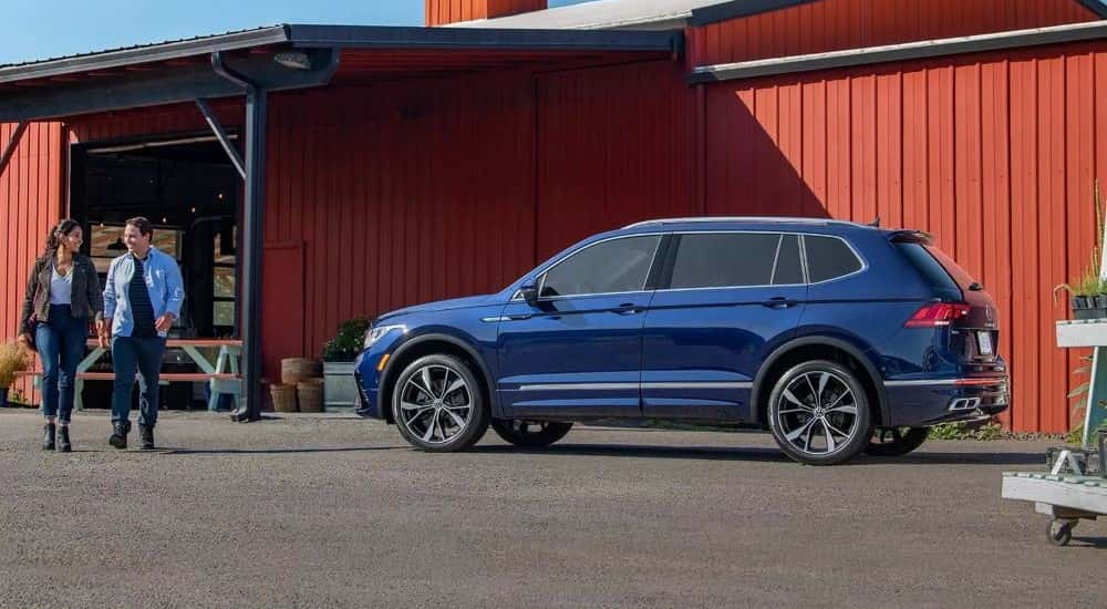 Blue 2023 Volkswagen Tiguan parked outside a red building
