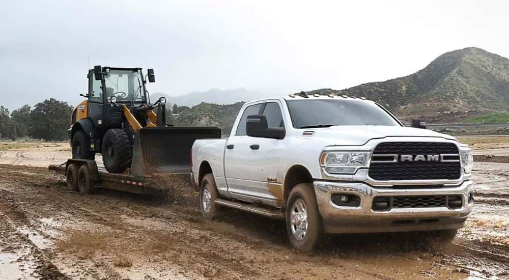 A white 2022 Ram 2500 towing a trailer.