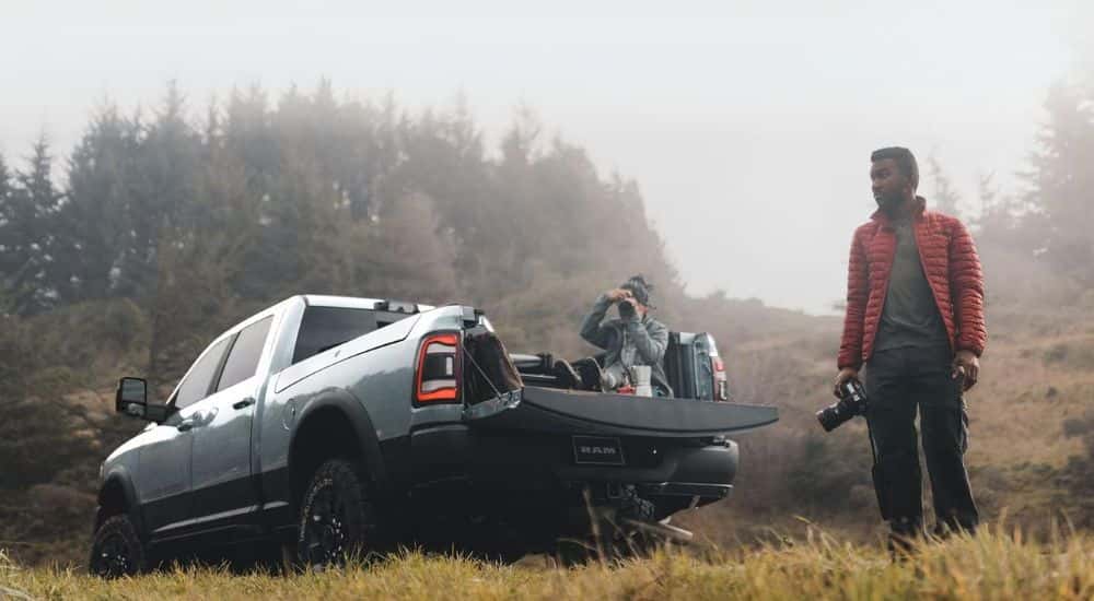 A photographer standing near a 2022 Ram 2500 for sale.