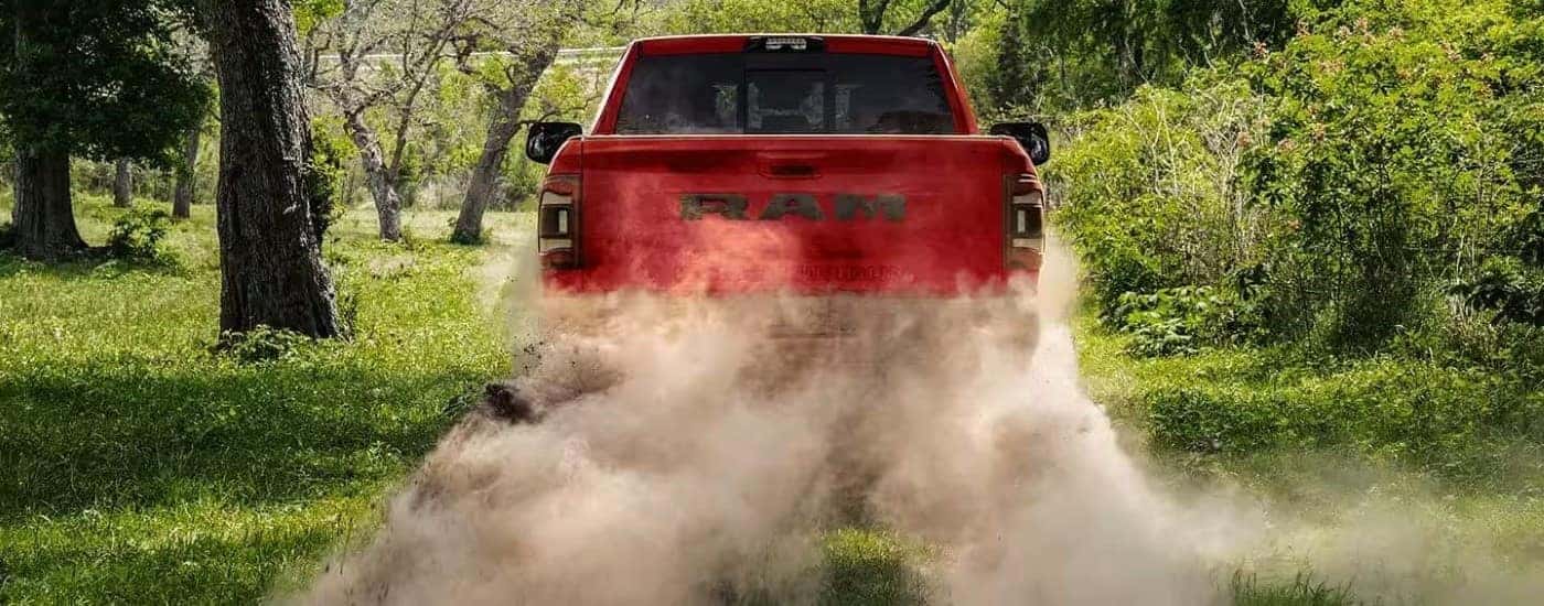 Red 2022 Ram 2500 driving down a dusty trail