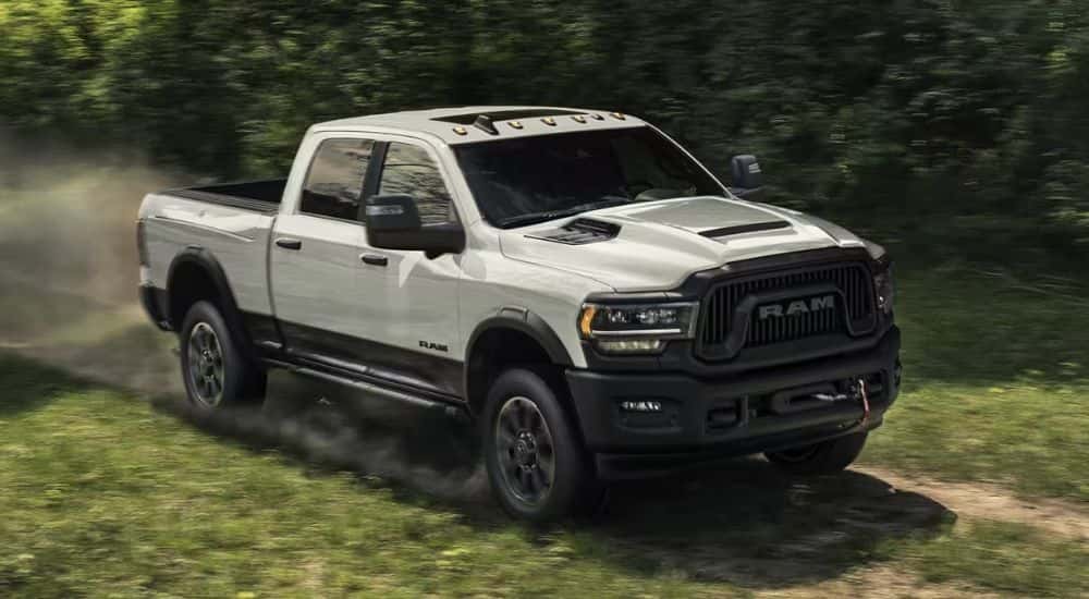 A white 2023 Ram 2500 Rebel off-roading for sale in Columbus