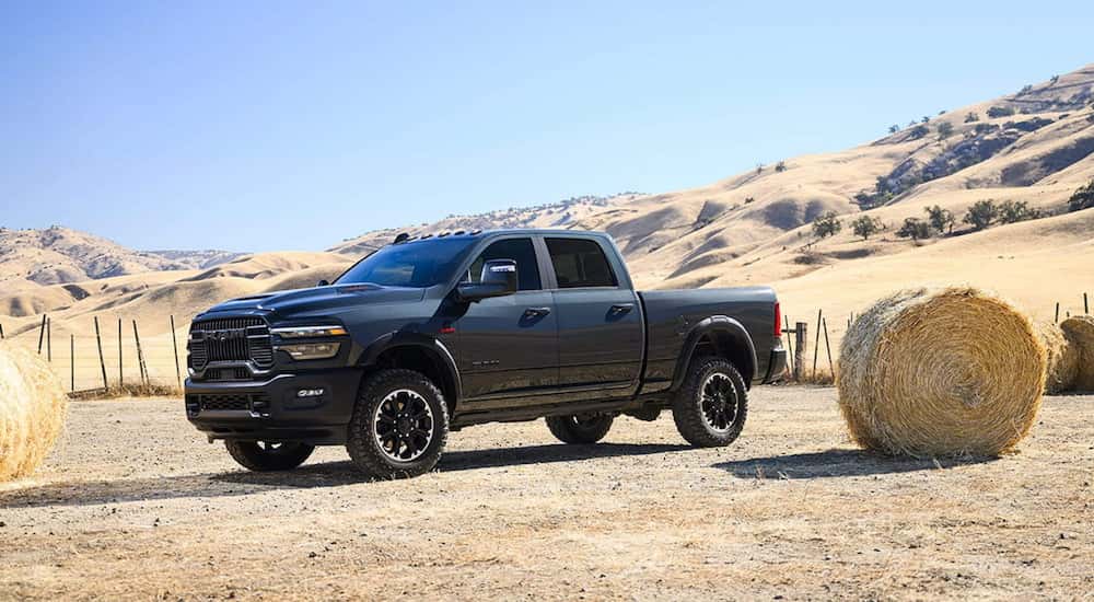 Side of a black 2025 Ram 2500 parked off-road.