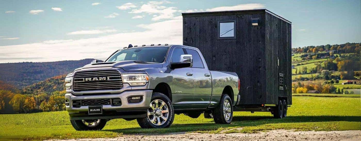 A gray 2023 Ram 2500 parked towing a shed