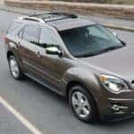 Grey 2012 Chevy Equinox LTZ driving down a road.