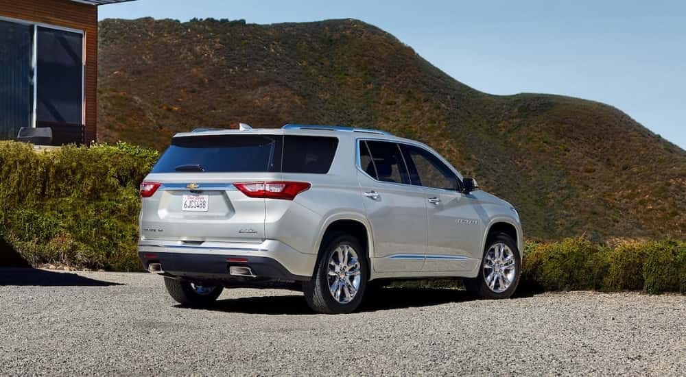 Rear of a white 2020 Chevy Traverse parked off-road.